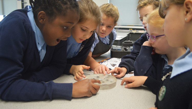 Children touch the actual moon